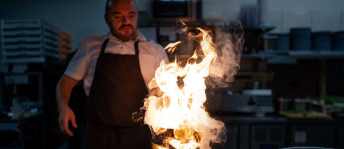 Chef cooking on an open fire