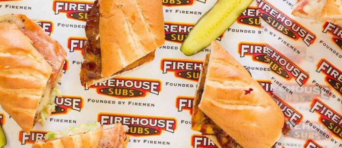 Firehouse Subs on wrapper with sliced pickle beside sandwich