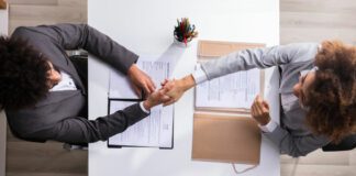 Elevated View Of A Male Manager Shaking Hands With Applicant at Workplace