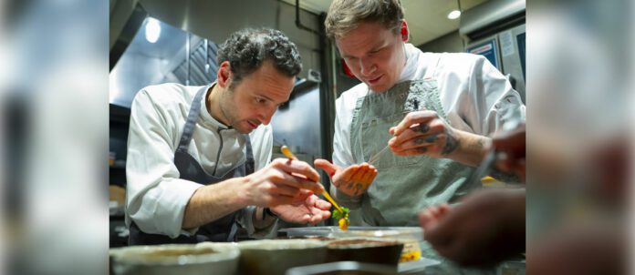Chef John-Vincent Troiano of FRILU and chef Joel Gray of Down Home collaborate on a dish featured at the inaugural A Taste of the Future dining event, presented by Mercedes-Benz in partnership with The MICHELIN Guide. (CNW Group/Mercedes-Benz Canada Inc.)