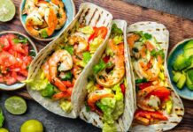 Shrimps tacos with salsa, vegetables and avocado. Mexican food