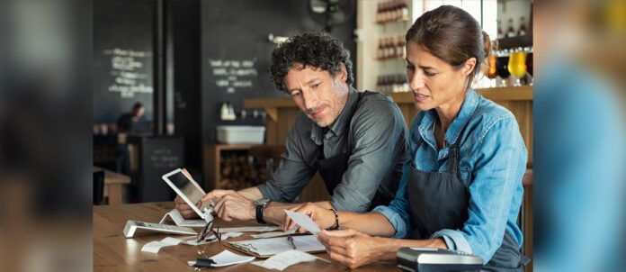 Restaurant staff calculating restaurant bill