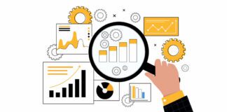 Man holding magnifying glass looking at charts and data