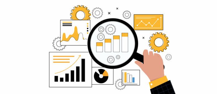 Man holding magnifying glass looking at charts and data