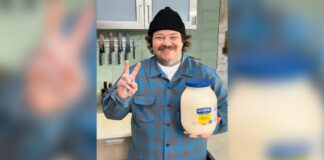 Chef Matty Matheson holding a large bottle of Hellman's mayonnaise