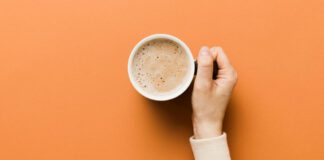 Woman's hand holding a cup of coffee
