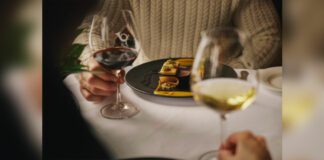 Woman enjoying glass of wine at Post Hotel