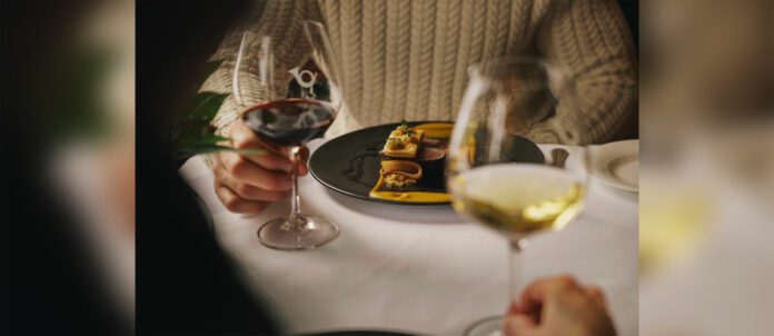 Woman enjoying glass of wine at Post Hotel