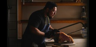Head chef at Savio Volpe, Jorge Sora cutting beef in kitchen