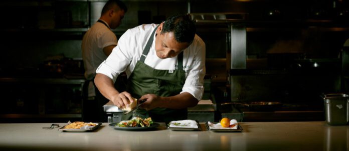 Chef Hector Laguna creating a gourmet caesar salad