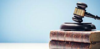 Hammer and gavel laying on top of books