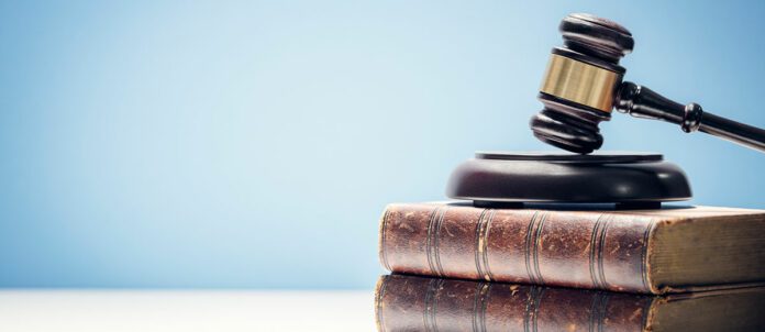 Hammer and gavel laying on top of books