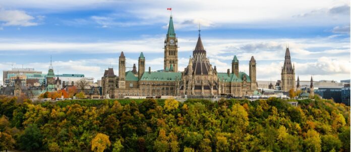 Stunning autumn view of Parliament Hill across the Ottawa River in Ottawa, Canada