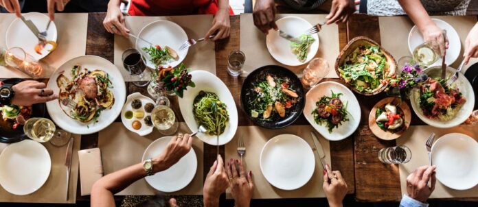 Group of friends having dinner at gourmet restaurant