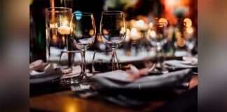 Luxury table settings for fine dining with and glassware, pouring wine to glass.