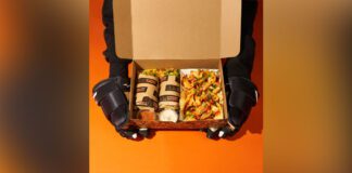 Hockey player holding box of Fat Bastard Burritos