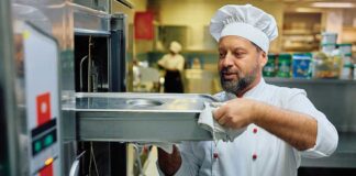 Chef taking food out of industrial oven