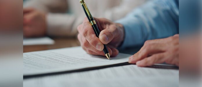 Closeup of CEO hands signing contract in office