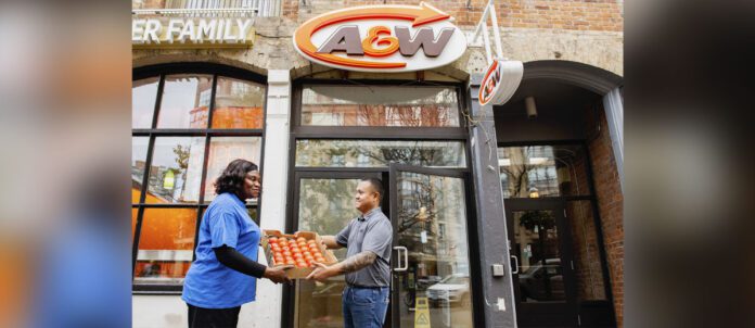 A&W Employee handing box of food to Second Harvest employeee