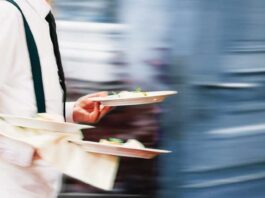 Waiter holding two plates of food