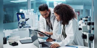 Two scientists working together to test samples in lab