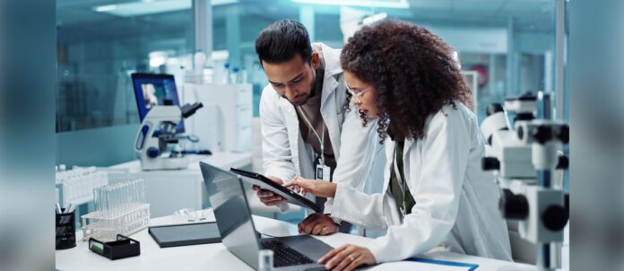 Two scientists working together to test samples in lab