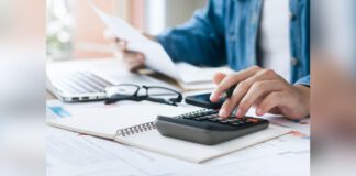 Man calculating taxes and costs with calculators