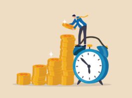 Employee stacking up coins standing on a clock