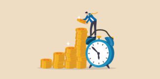 Employee stacking up coins standing on a clock