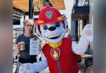 Beertown Public House Dog mascot next to customer