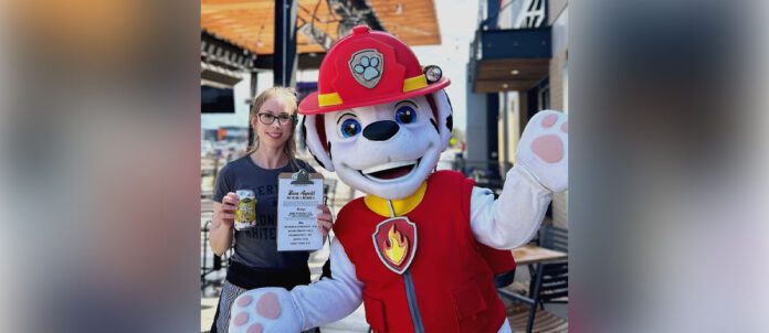 Beertown Public House Dog mascot next to customer