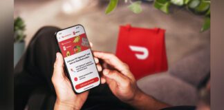 Person holding cellphone with DoorDash app open linking to PC Optimum