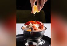 At Riley’s Fish & Steak, server squeezes lemon on meal