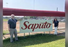 Saputo Legacy Program team in front of baseball dugout