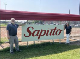 Saputo Legacy Program team in front of baseball dugout