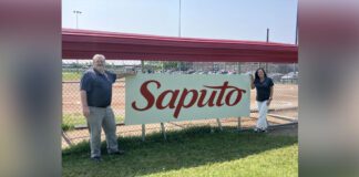 Saputo Legacy Program team in front of baseball dugout
